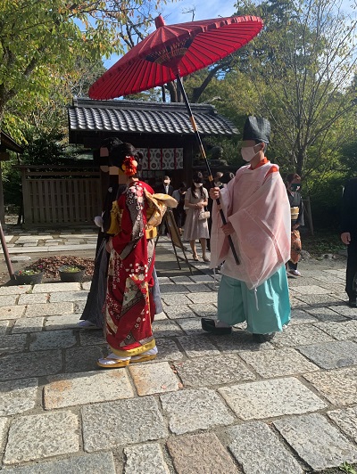 参進の儀の際の赤色のリメイク引き振袖を着た花嫁と花婿
