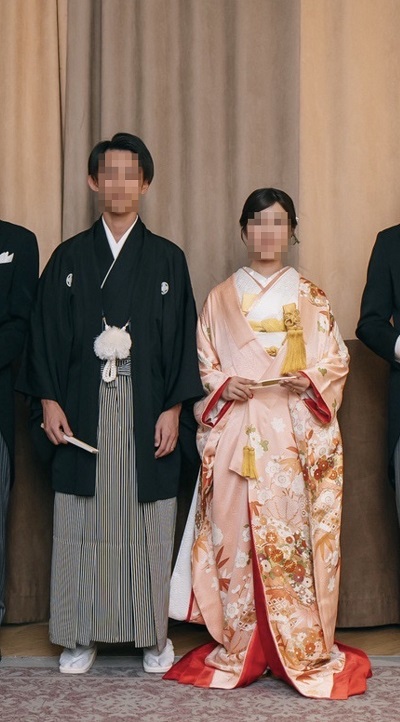 ピンク色のリメイク打掛を着た花嫁と花婿